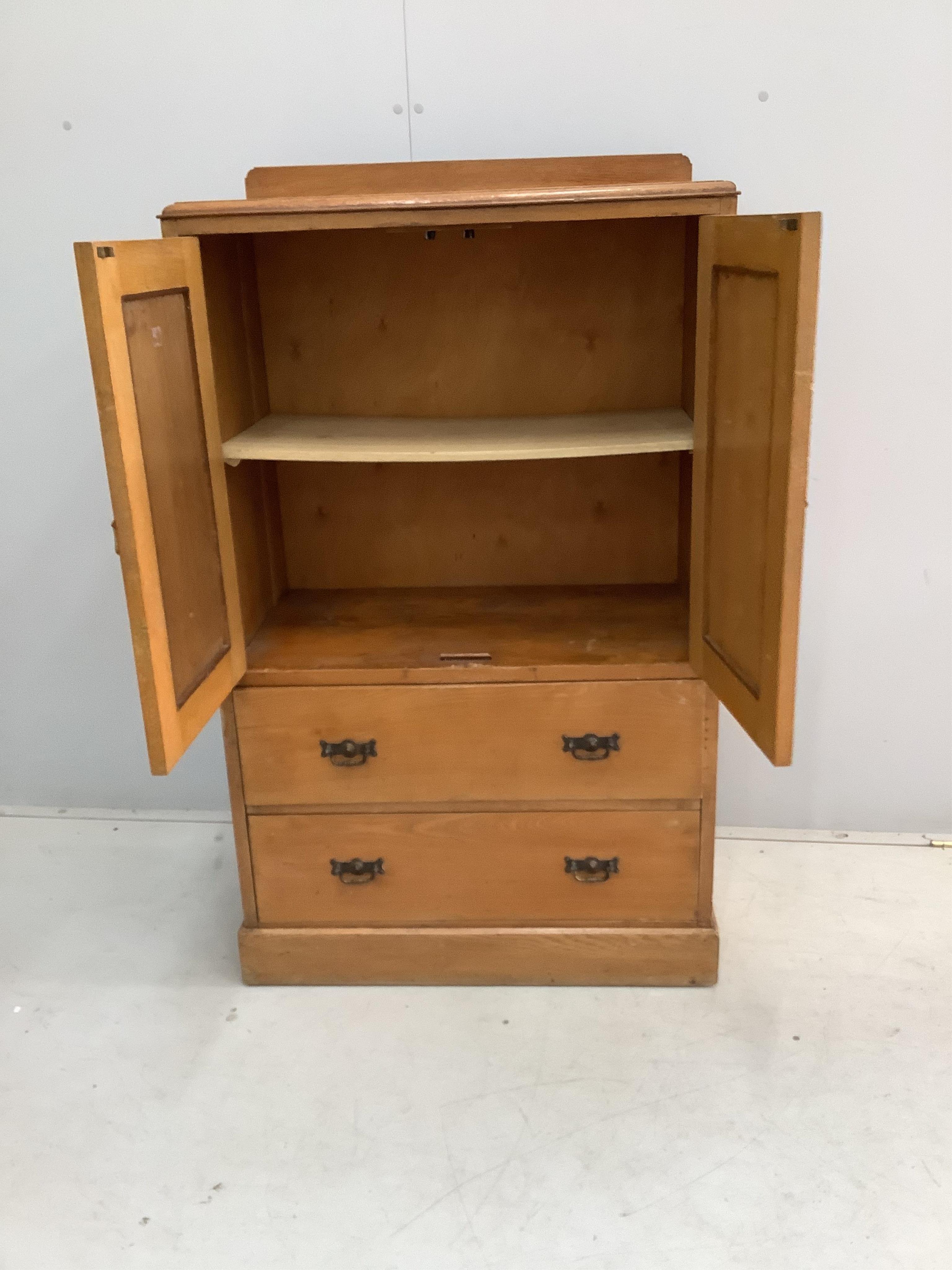 An early 20th century small oak press cupboard, width 75cm, depth 42cm, height 124cm